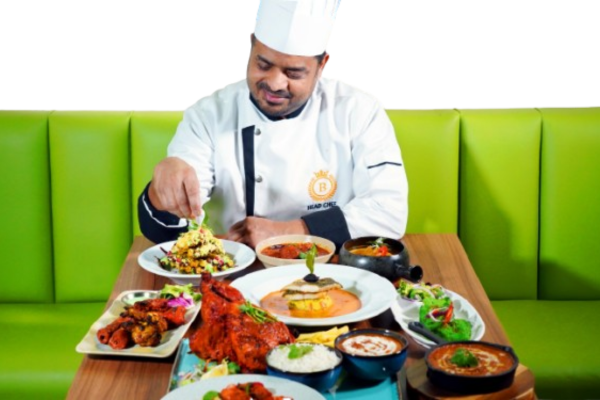 Chef Beerpal plating a spread of Indian dishes at Bukharaa in Romiley
